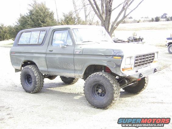 1978 Ford Bronco with large off-road tires and lifted suspension, parked outdoors