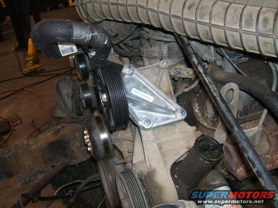 engine bay with new water pump and pulleys installed