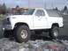 1983 Ford Bronco - This lifted Ford Bronco is parked in a lot with snow on the ground, with a Safeway store visible in the background.