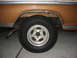 1972 Ford F-100 - Close-up of a truck's rear wheel and fender area, showing the tire and rim.