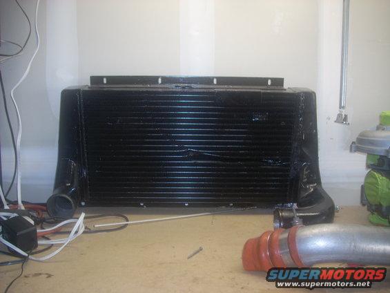 Black intercooler with silver piping and red couplers