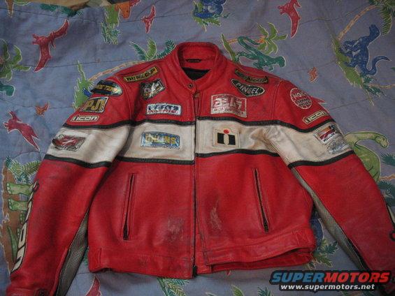 Red and white leather motorcycle jacket with multiple sponsor patches, including Yoshimura and Icon