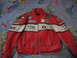 2005 Yamaha R1 - A red and white leather motorcycle jacket is displayed with various sponsor patches.