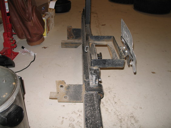 Trailer hitch assembly with a license plate attached, viewed from the side