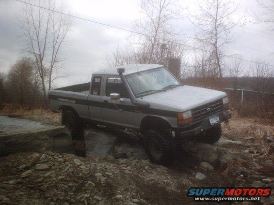 Silver 1990 Ford Ranger on rocks, 3q-front view