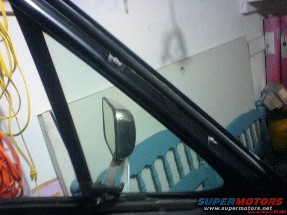 Interior view of a car's side mirror and window frame