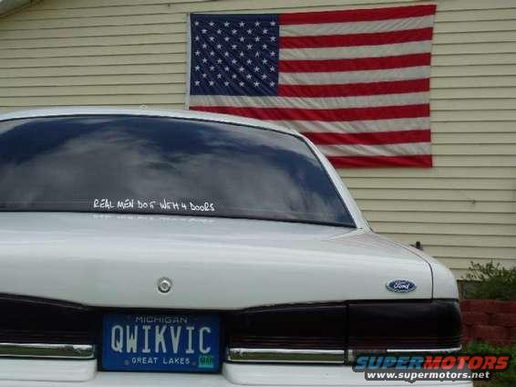 White 1996 Ford Crown Victoria rear view with Michigan license plate QWIKVIC