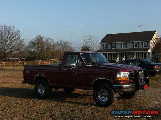 1992 Ford F-150 pickup truck parked in a grassy yard with a house in the background