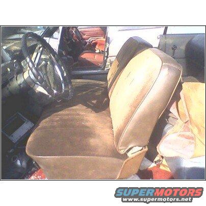 Interior view of a car, showing brown seats, dashboard, and steering wheel