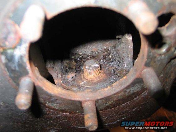 Rusted wheel hub with visible bolt and studs