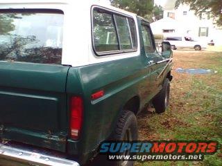Green 1978 Ford Bronco with white top, rear quarter view, parked outdoors