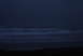 1993 Ford Bronco - The image shows waves crashing on a beach during twilight, with a website address visible in the corner.