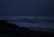 1993 Ford Bronco - Waves roll onto a dark shore under a deep blue sky.