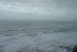 1993 Ford Bronco - The vast ocean churns with waves under an overcast sky, a watermark from SUPERMOTORS.NET.