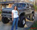 1970 Mercury Cougar - A woman stands next to a lifted Ford Bronco with oversized tires.