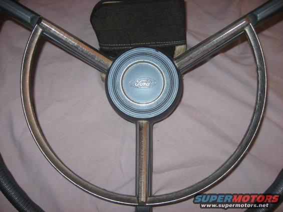 Ford steering wheel with blue horn button and chrome trim