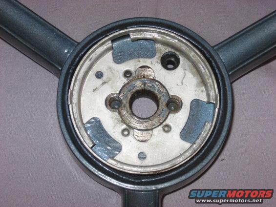 Gray steering wheel hub with three spokes visible