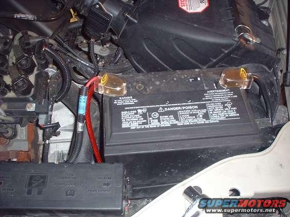 Engine bay shot showing car battery, fuse box, and wiring