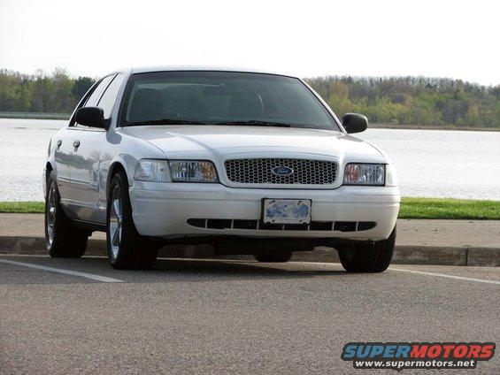 2003 Ford Crown Victoria parked facing front, water and trees in background