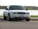 2003 Ford Crown Victoria - White 2003 Ford Crown Victoria parked near a lake on a cloudy day.