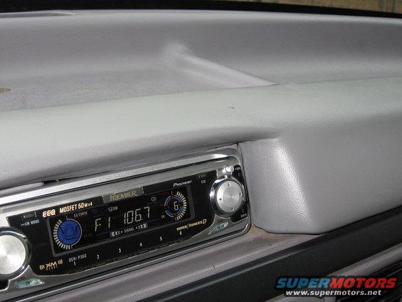 Dashboard interior with Pioneer Premier stereo, showing F1 106.7 display