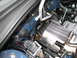 2007 Subaru Impreza - Close-up view of engine bay components, including a COBB branded heat shield and various hoses and wiring.