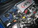 2007 Subaru Impreza - Close-up of a modified Subaru engine bay, an APS intercooler and various engine components.