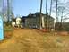 1979 Ford Ranchero - A large house is under construction, with vehicles and a portable toilet on site.