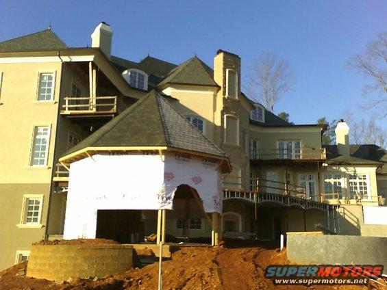 Construction scene with large house and scaffolding