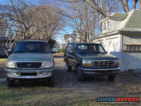 1997 Ford Expedition and a green Ford Bronco parked outside