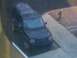 1994 Ford Bronco - A dark SUV is seen from a high angle, with water visible on its roof.