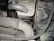 1994 Ford Probe - This image shows a close-up view of a damaged engine hose and its connection point, likely for maintenance or repair.