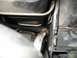 1994 Ford Probe - A close-up view of a metal hose and corrugated tubing within an engine compartment.