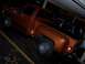 1979 Chevrolet C/K Pickup - An orange pickup truck is parked under a covered area at night.