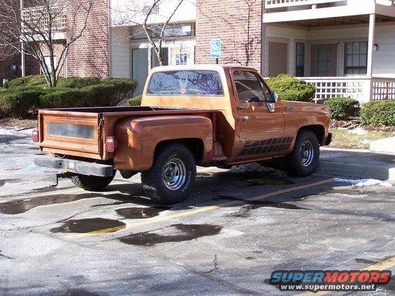 Rear 3/4 view of a brown 1977 Chevrolet C/K pickup truck parked in a lot