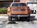 1979 Chevrolet C/K Pickup - Rear view of an orange 1979 Chevrolet C/K Pickup truck, parked in a lot.