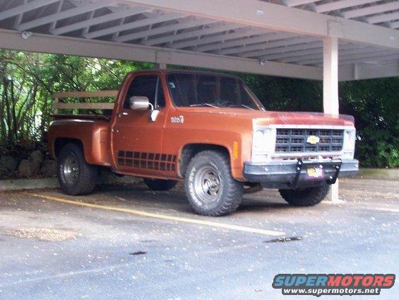 1979 Chevrolet C/K Pickup truck parked under a carport, front 3/4 view