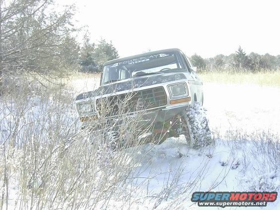 1978 Ford Bronco front view in snow with "FOUR PLAY" sticker on windshield