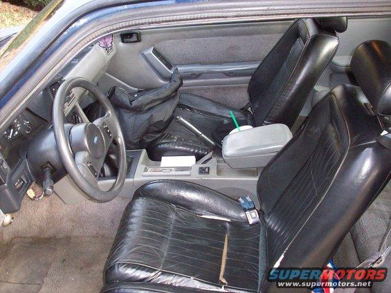 1989 Ford Mustang interior showing front seats, dashboard, and center console
