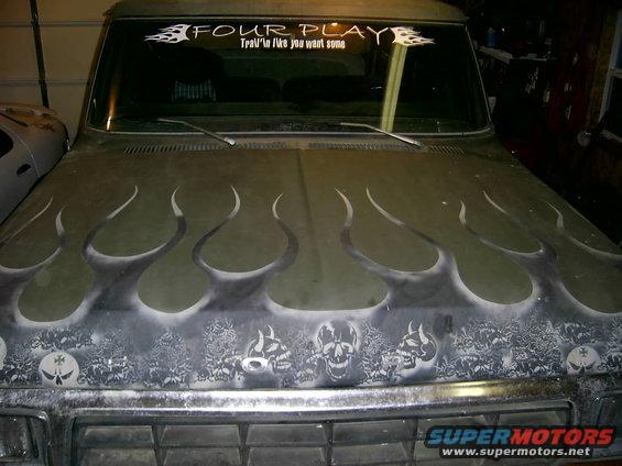 Truck hood with flame and skull airbrushing. Windshield banner says "FOUR PLAY"