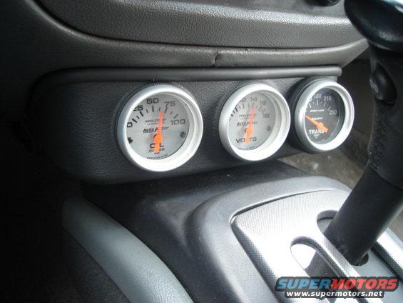 Dashboard with three aftermarket gauges: oil pressure, voltage, and transmission temperature