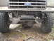 1989 Ford Bronco - Front view of a Ford truck with a custom winch mount and large off-road tires, suggesting an earlier model year.