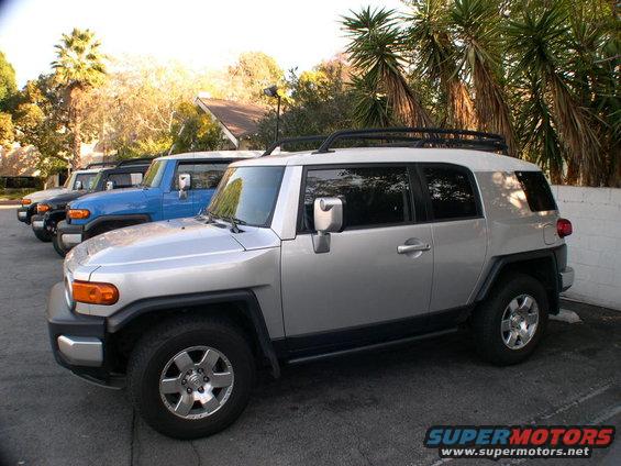 Silver 2007 Toyota FJ Cruiser in foreground, with blue and black FJ Cruisers behind it