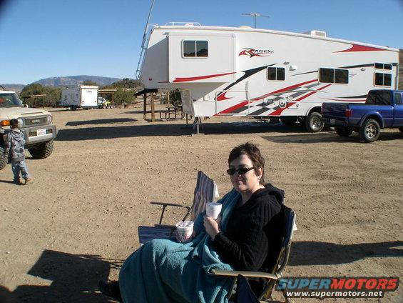 2007 Toyota FJ Cruiser parked next to a large white RV with red and black graphics