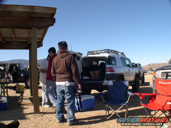 Silver 2007 Toyota FJ Cruiser with open rear hatch and roof rack, parked outdoors