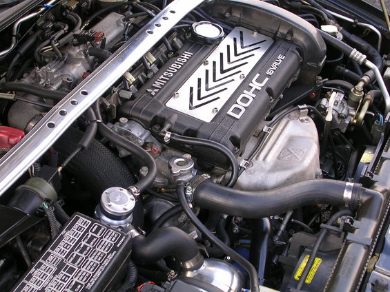 Mitsubishi DOHC 16 valve engine with aftermarket blow-off valve and strut bar