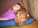 2001 Ford Crown Victoria - A dog and a young child relax together on a pillow, with the dog's head resting comfortably beside the child.