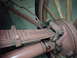 1912 Ford Model T - Detail of the suspension and wheel assembly, showing a leaf spring and hub with wooden spokes.
