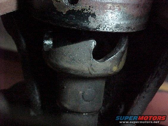 Close-up of a metal suspension component with a hook-like shape