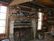 1995 Ford Bronco - A cozy cabin interior features a roaring fire in the stone hearth, with hunting trophies adorning the log walls.